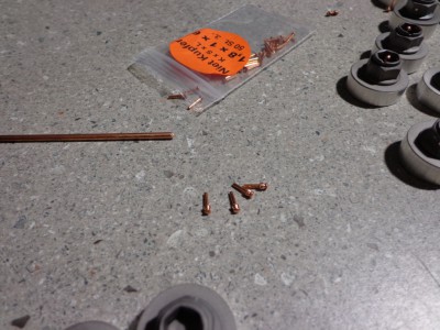 I file a small chamfer on the end of the copper tube then slide it onto the rivet