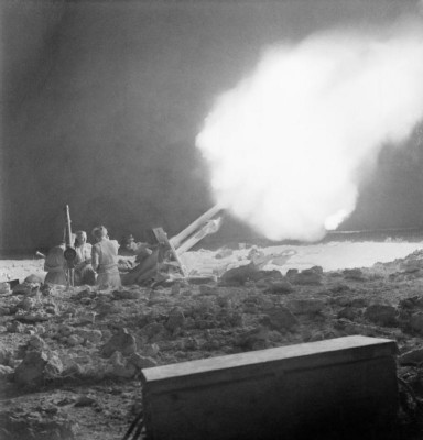 British_25-pounder_field_guns_in_action_on_the_night_of_2_June_1942_during_the_Battle_of_Gazala_in_Libya._E12789.jpg