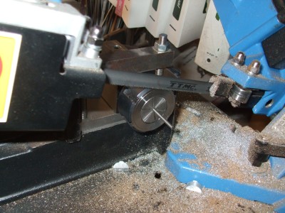 Using the band saw and an ER32 square block to cut studs.