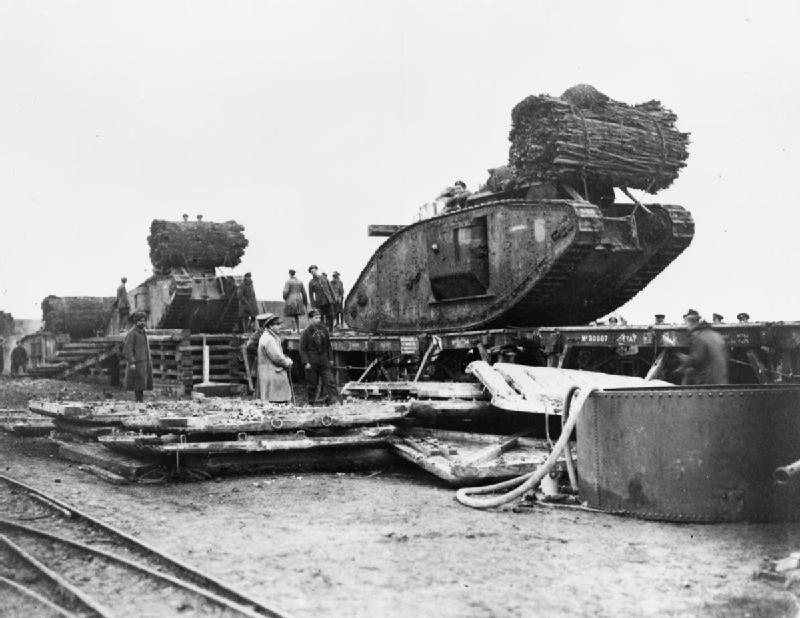 British-Mark-IV-Female-Tanks-being-loaded-aboard-railway-trucks-at-Plateau-Station-in-preparation-for-the-Battle-of-Cambrai.-IWM.jpg