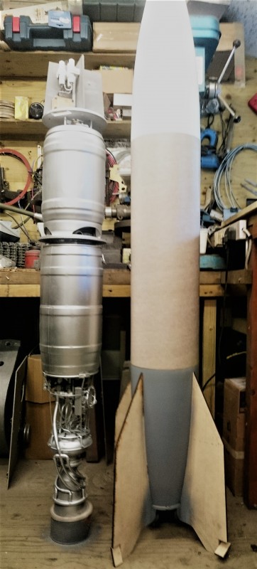 The rocket motor is sitting on a tin to raise it up to the correct height in relation to the rocket body.