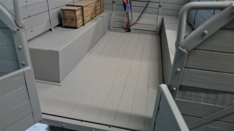 The bed now has a timber plank floor. The cables are pulled through the timber cargo area wall and ready to be threaded into the crate.