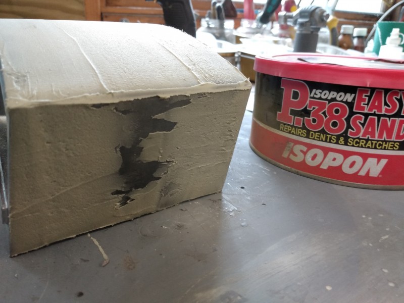 Apply the body filler to the front and sides, the rear will never be seen so it's not worth it unless you cant sleep over it. Well maybe a round the lifting lug area might be a good idea.