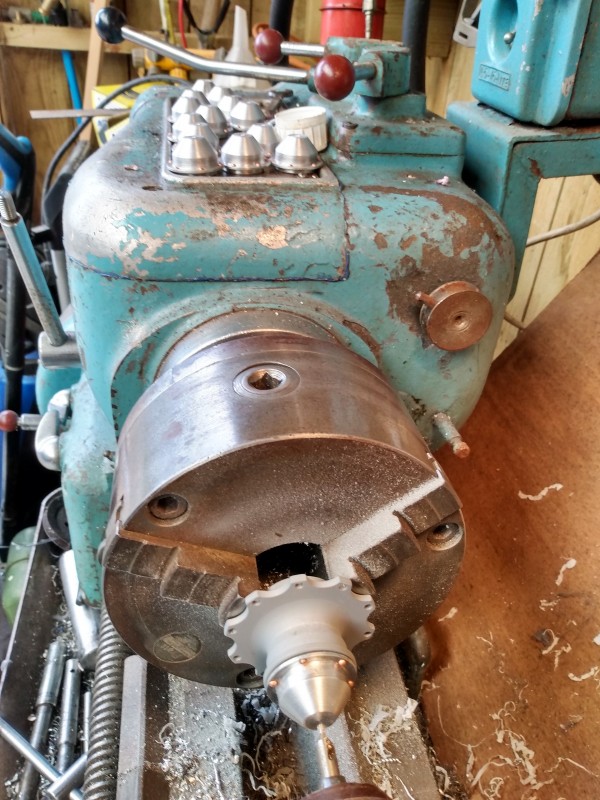 Some days it's like a little production line in the machine shop.Centre drilling the hub caps before a 3mm hole to accept the little brass piece. I'm using the hub thread to hold the fragile hub cap for the machining process.