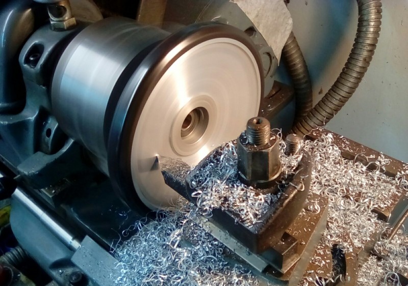 Turning down the sand casting finish.