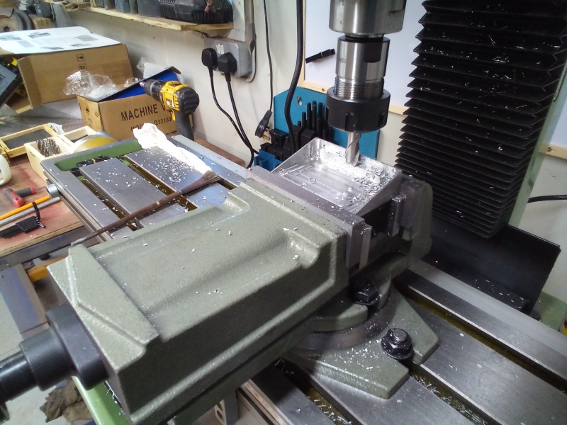 Machining the upturned locker lid.