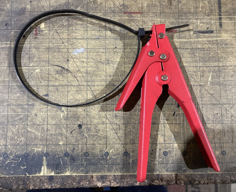 Showing without tire/rim, The small handle on the left side is the cutter if you want to cut the tails off, But i re-use the cable ties as they are expensive to use once £15+ per 100 so don't use this.